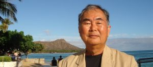 Headshot of Patrick Takahashi with Diamond Head in the background.