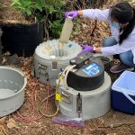 Engineering students handling wastewater samples.