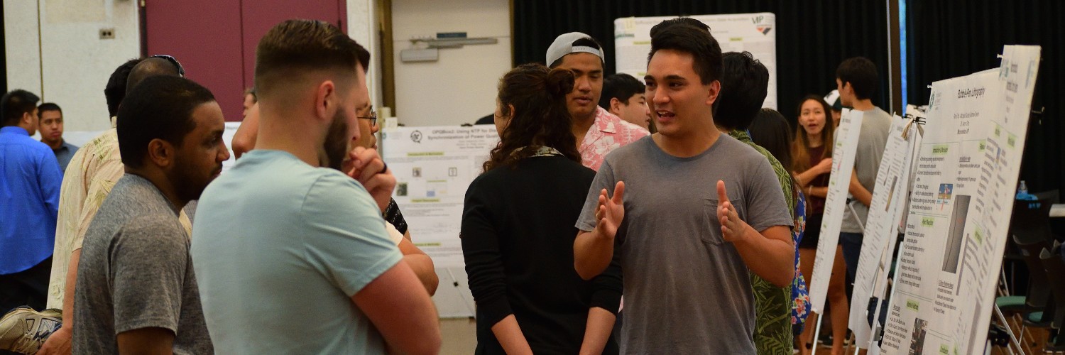 Student Explaining His Project To Curious Onlookers.