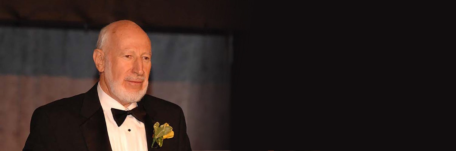 Dr. Norm Abramson Standing At A Podium