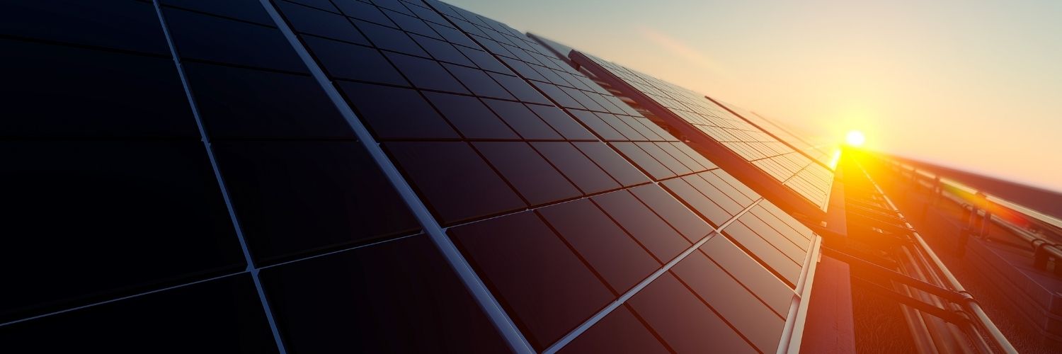 Photo Of Sun Setting Over Some Solar Panels