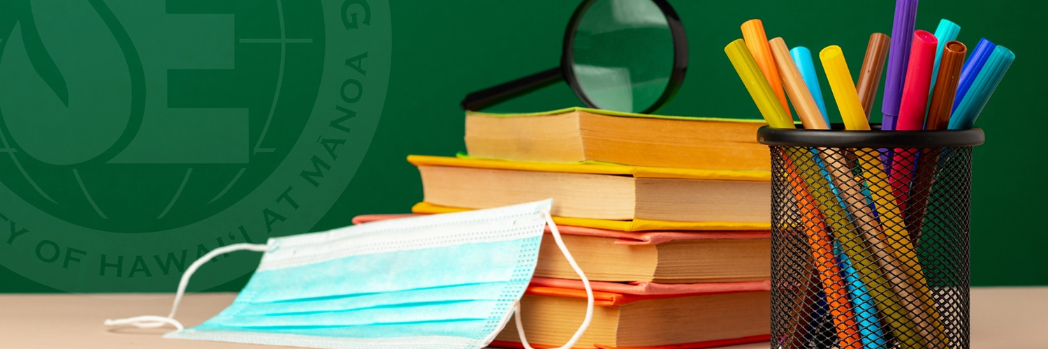 Books, Pens, And A Mask On A Desktop