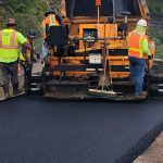 Road crew laying new asphalt