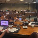 Photo of people listening to a lecture in a large room
