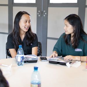 Two Wāhine Connect Students Conversing