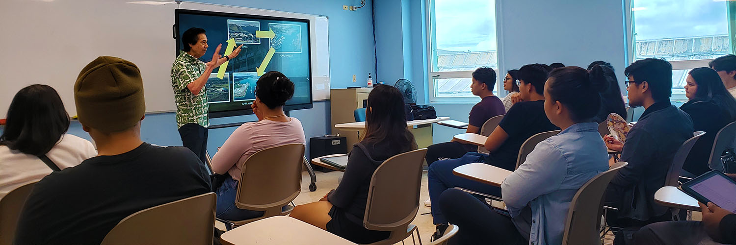 Professor Presenting To A Full Classroom