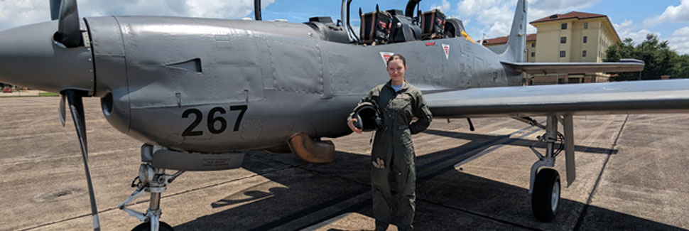 Sapphira Akins In A Flight Suit And Posing Next To An A-27 Tucano