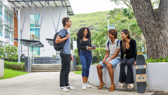UH Manoa Students Sitting And Standing Around, Enjoying Each Other's Company